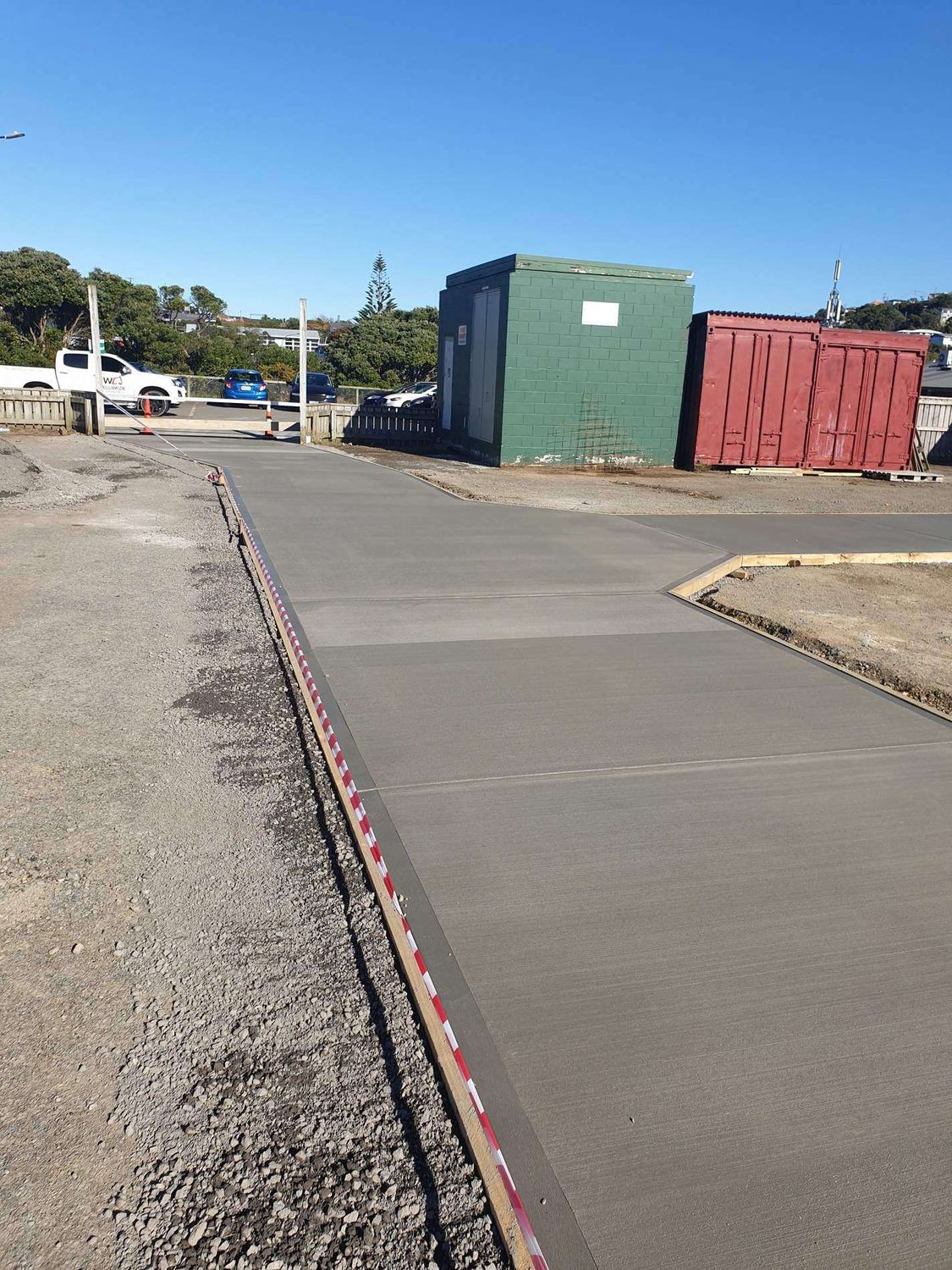 Freshly poured concrete accessway with timber formwork along its edge